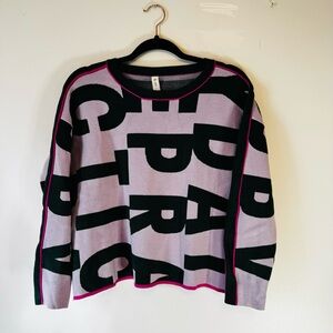 Daily Practice Knit Sweater in Lavender graphic lettering in green w/ Pink Trim